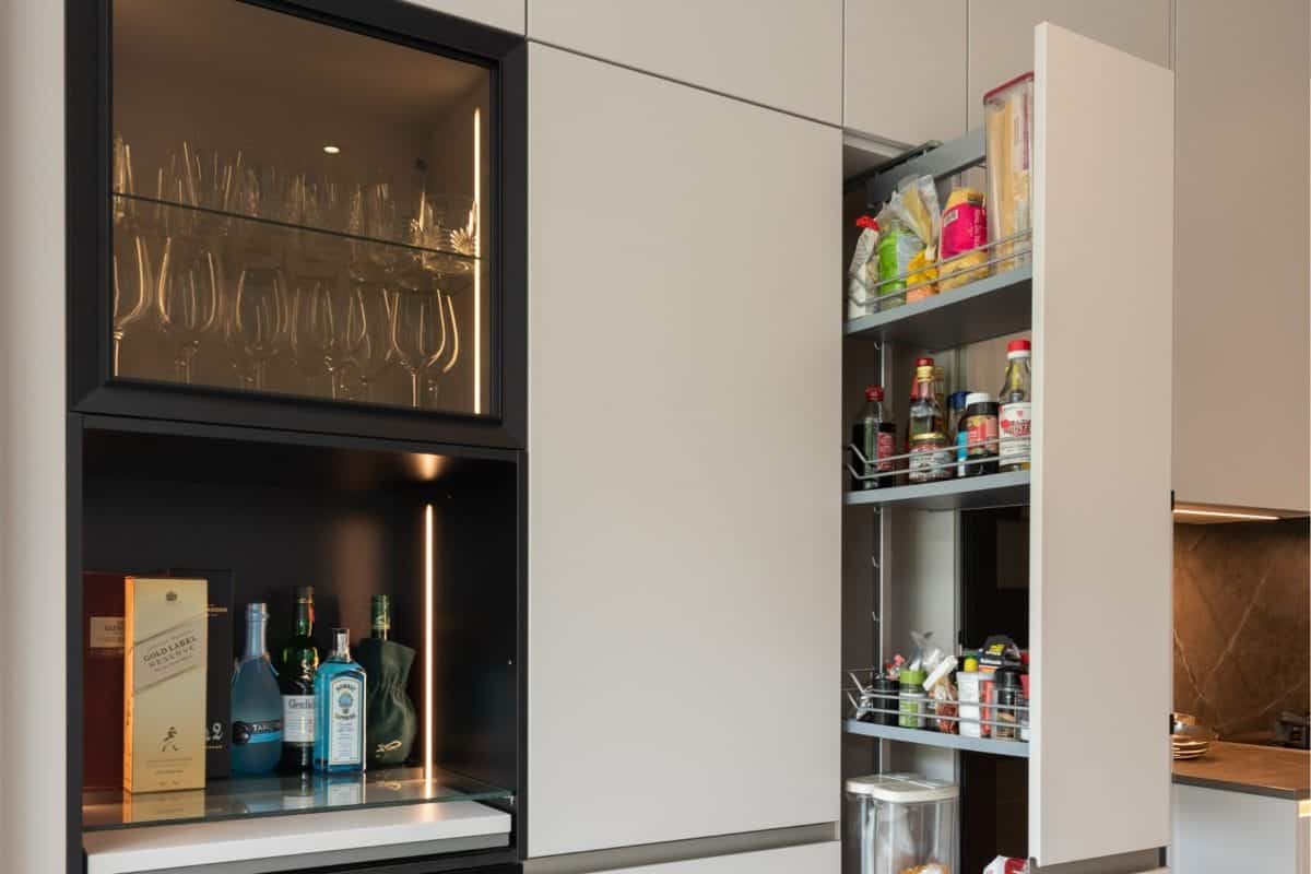 Bespoke kitchen storage with glassware cabinet, drinks shelf and pull-out larder pantry