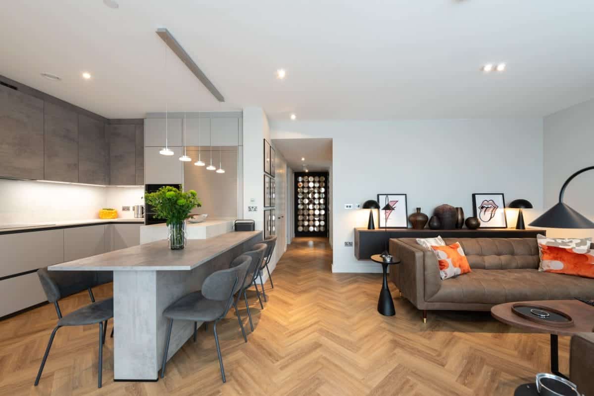 Ebstone Mackintosh open-plan kitchen in concrete grey with island dining, pendant lighting and herringbone oak floor