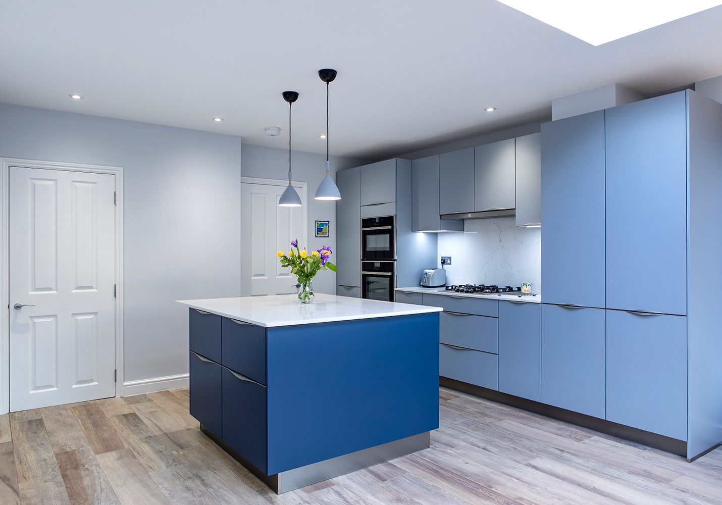 Modern Light Blue Kitchen with dark blue island